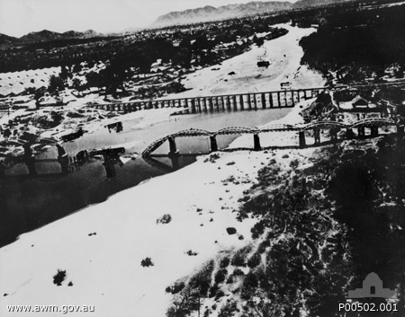 AERIAL PHOTOGRAPH OF THE BRIDGE OVER THE KWAI RIVER, THAILAND, SEVERELY DAMAGED BY AERIAL BOMBING
