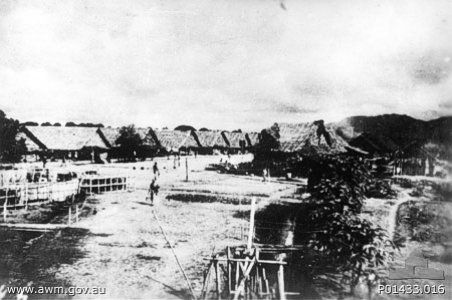 Kanchanaburi (Kanburi), Thailand. c. 1945. The prisoner of war (POW) officers' camp showing huts and parade ground